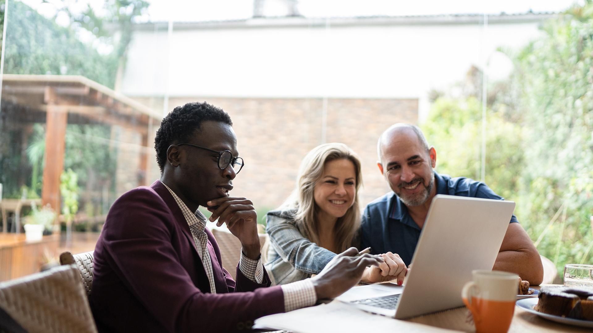 finance advisor doing a meeting with couple at home