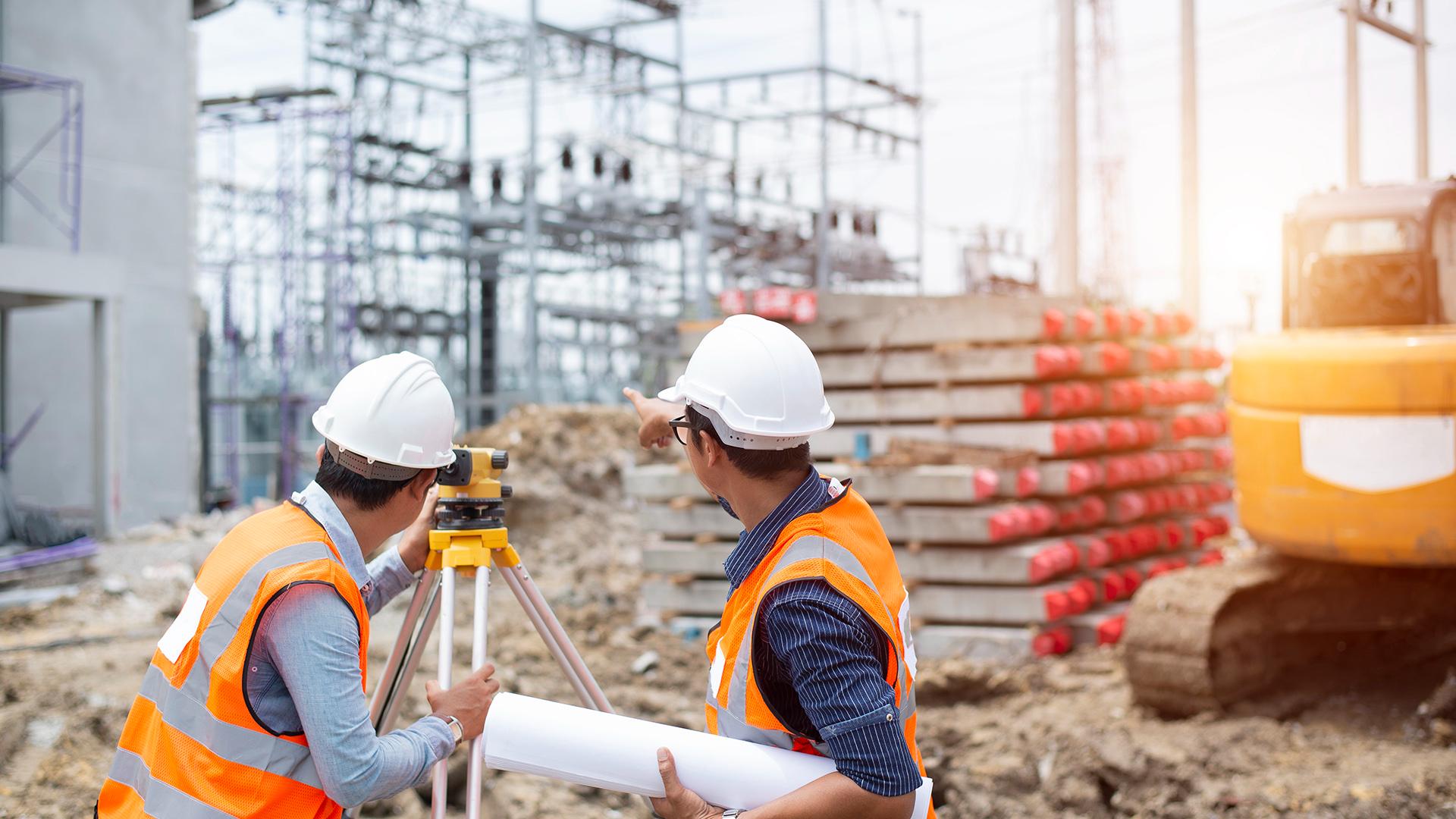 A construction surveyor engineer making measure with partner on the field