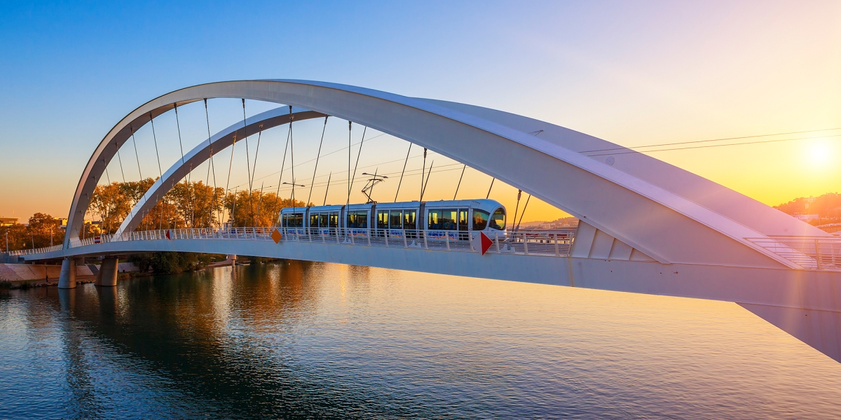 Tramway on the bridge at sunset