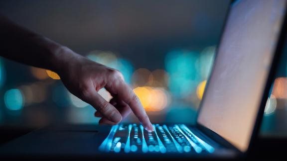 Close up of woman's hand typing on computer keyboard 