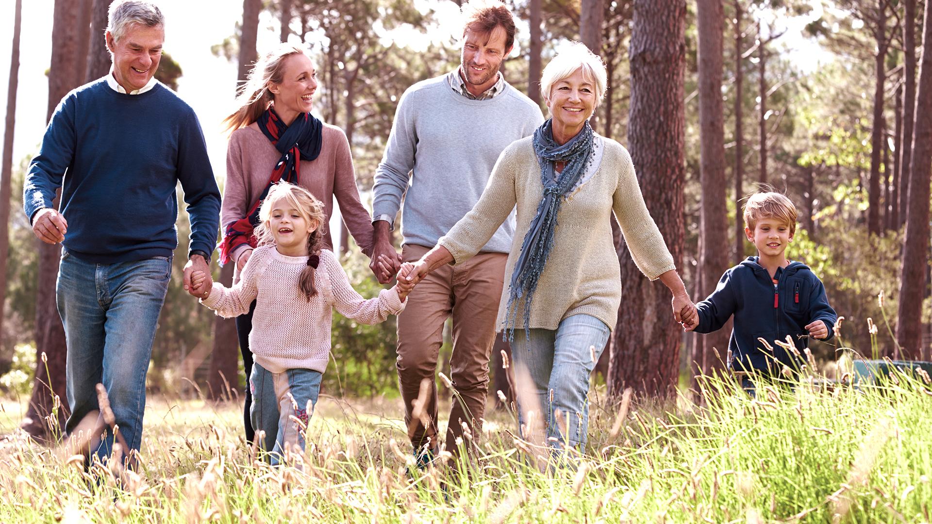 Happy multi-generation family walking in the countryside