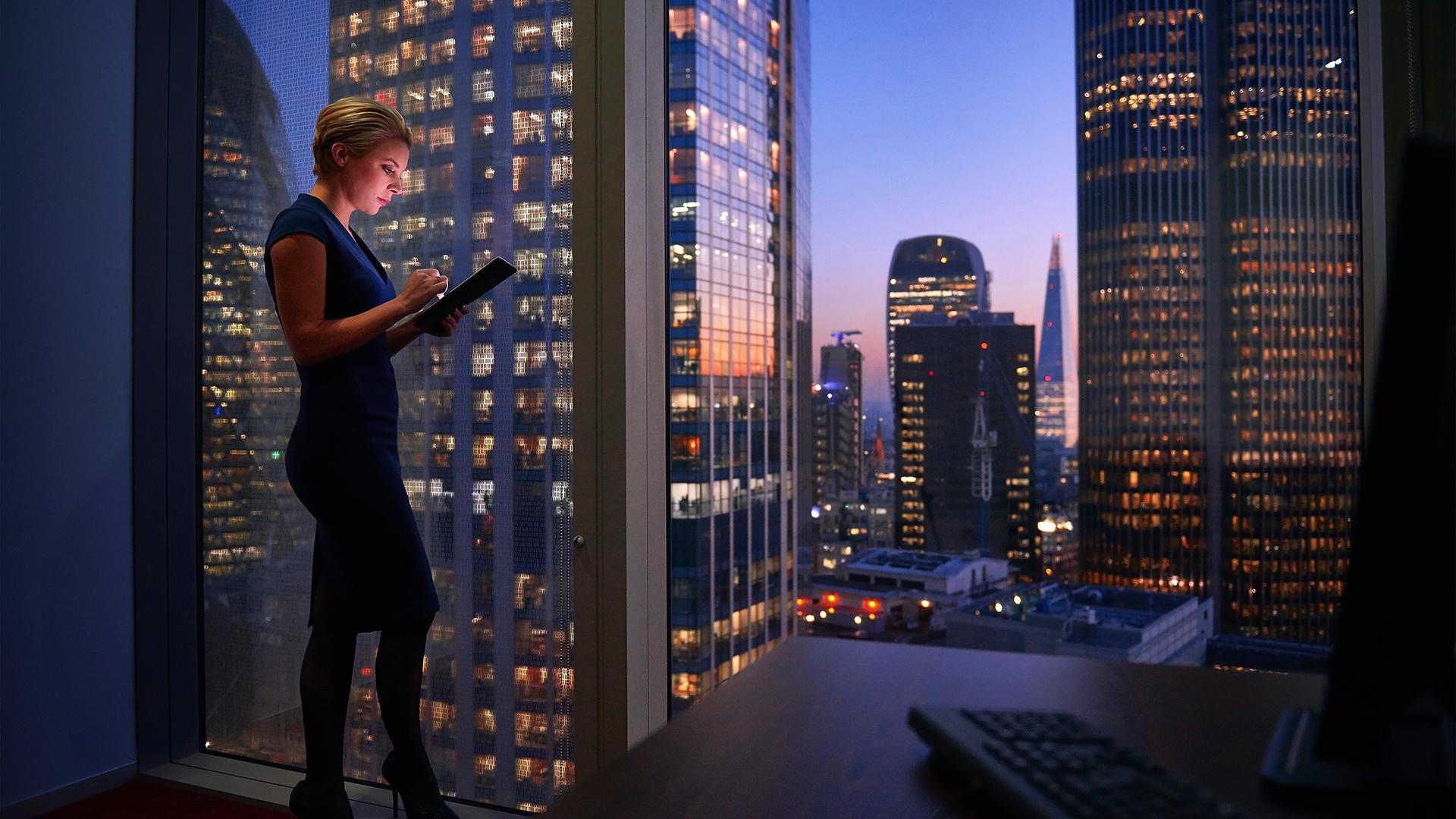 Businesswoman working late on digital tablet