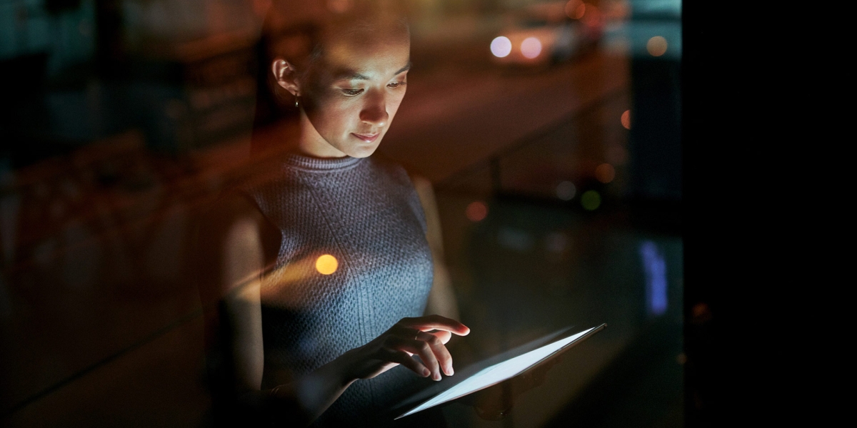 A woman working late on her ipad.