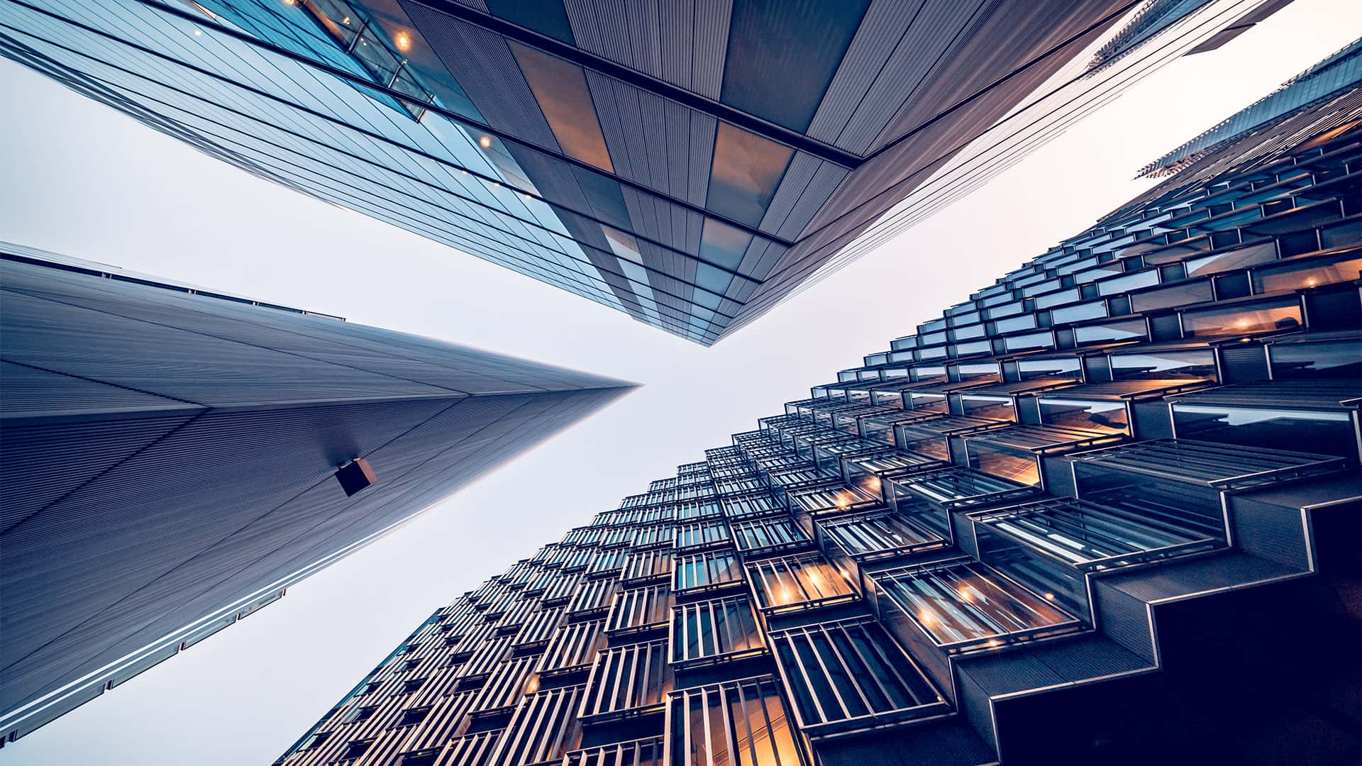 Looking directly up at the skyline of the financial district in central London