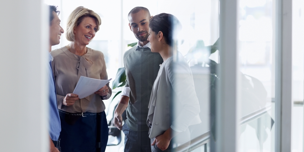 A CPA speaking and smiling with a young couple.