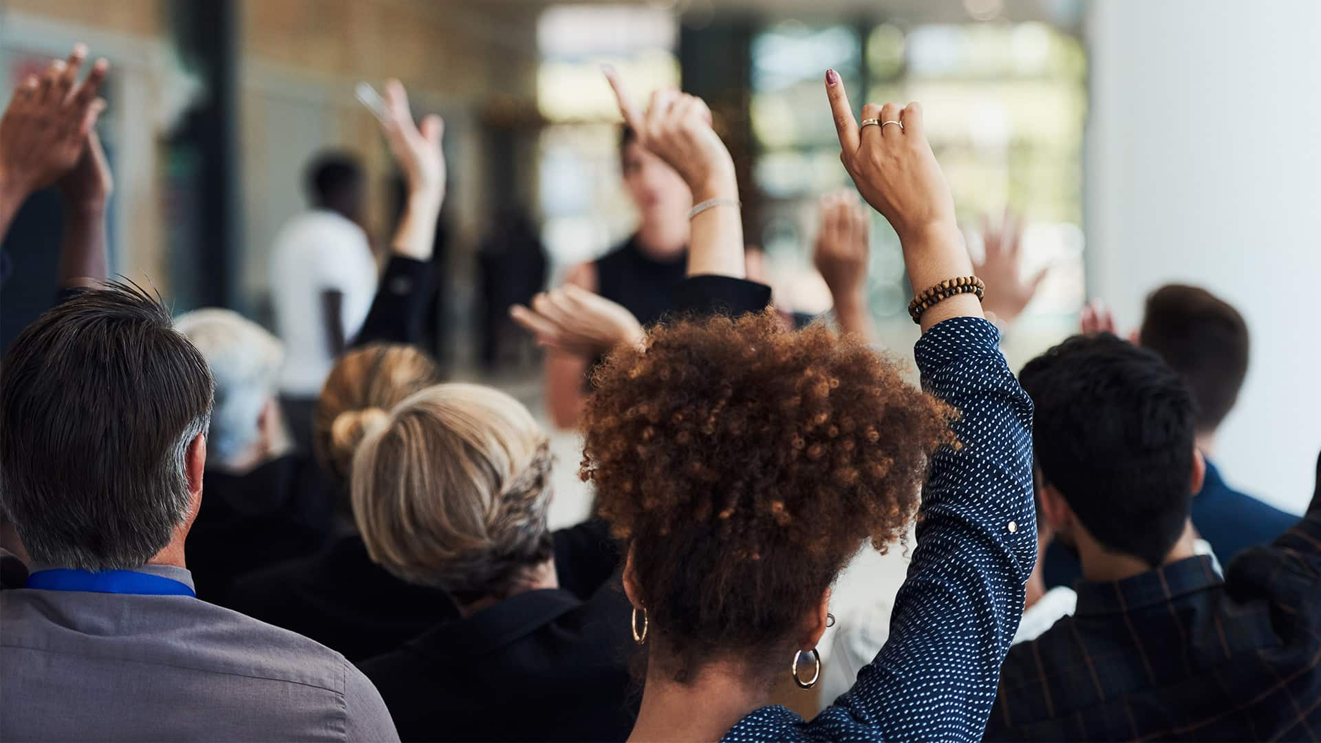 Hands raised at conference