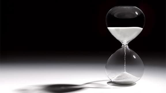 Hourglass that shows time running out.