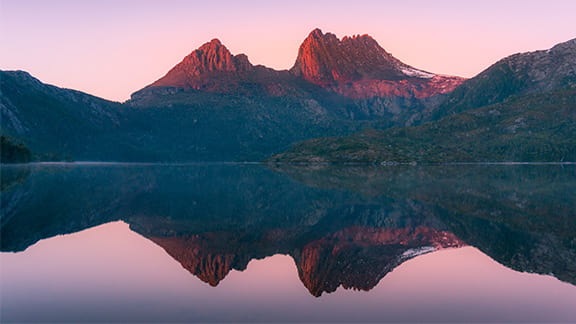 Mountain landscape at sunrise. Sunlit mountain peaks nature background