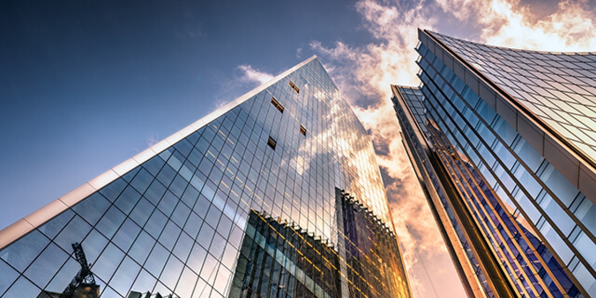 Looking Upward at Skyscrapers Reflecting Clouds