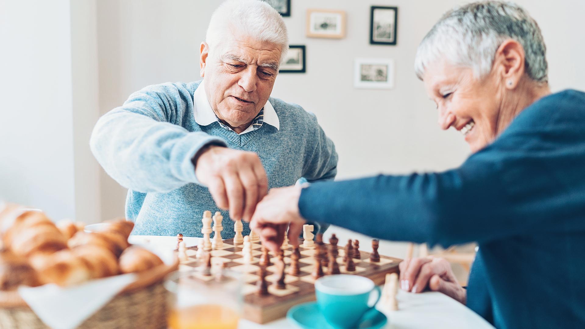 Two senior citizens playing a friendly game of chess.