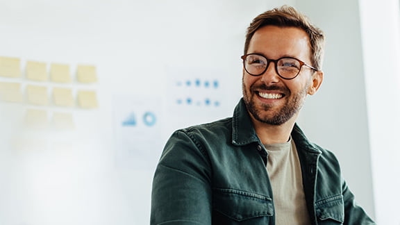 Happy business man listening to a discussion in an office