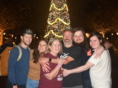 Brad Benton and family in front of a Christmas tree