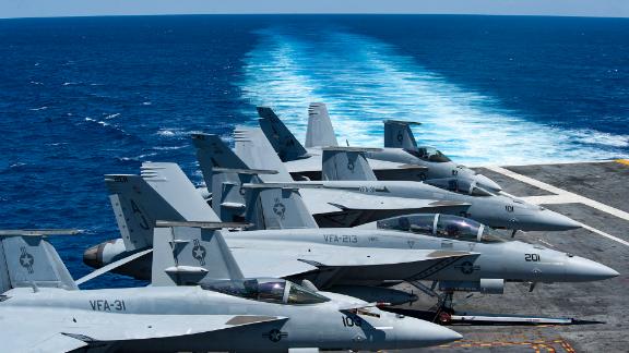 F/A-18 Super Hornets sit on the flight deck aboard the aircraft carrier USS George H.W. Bush. 