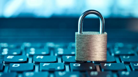 Key lock sitting on top of a computer keyboard signifying computer security