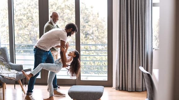 Full length shot of an adorable little girl dancing with her father and grandfather at home