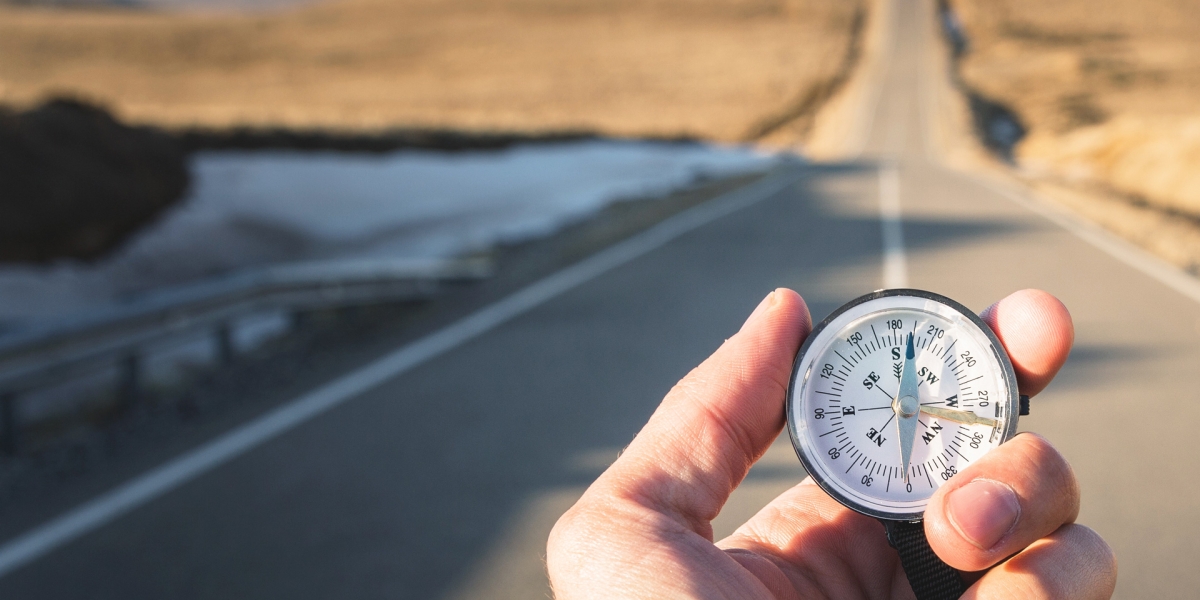 A person holding a compass.