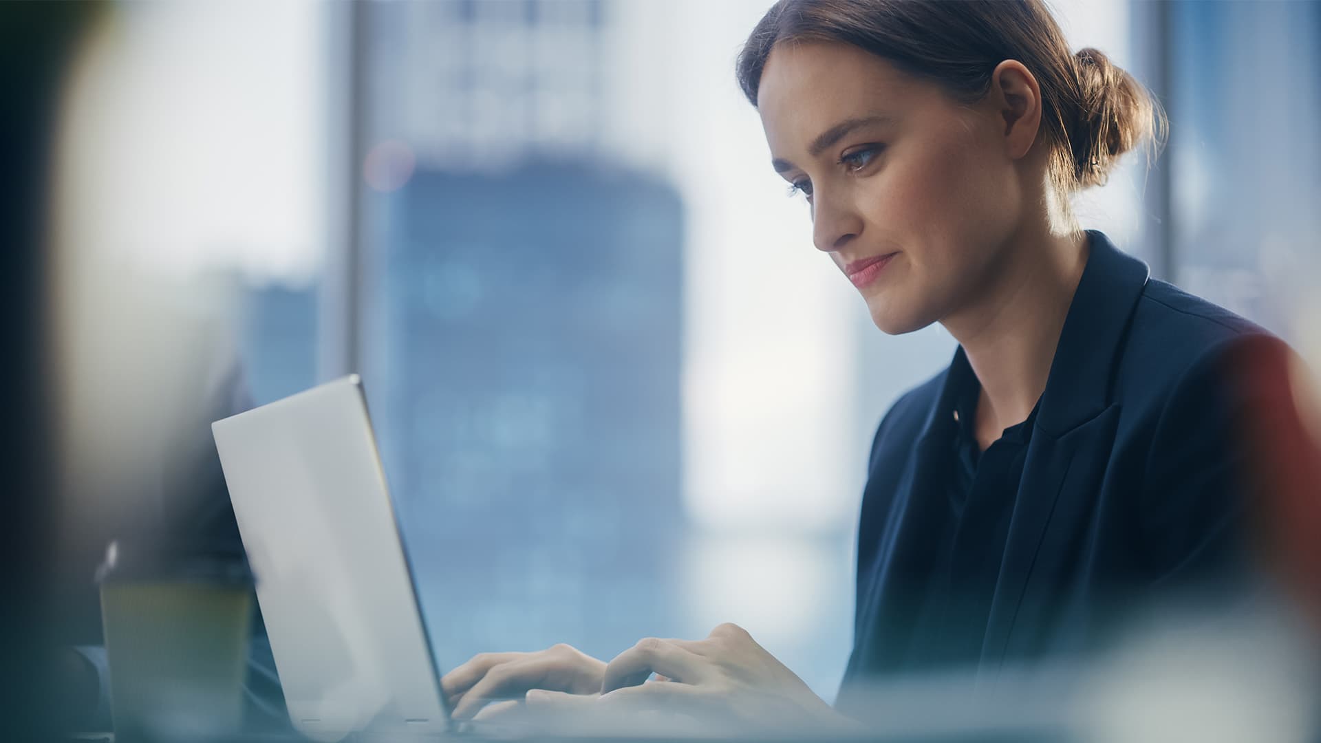 Determined woman typing on laptop