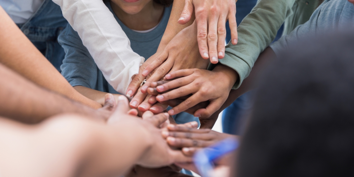 hands in with children and adults