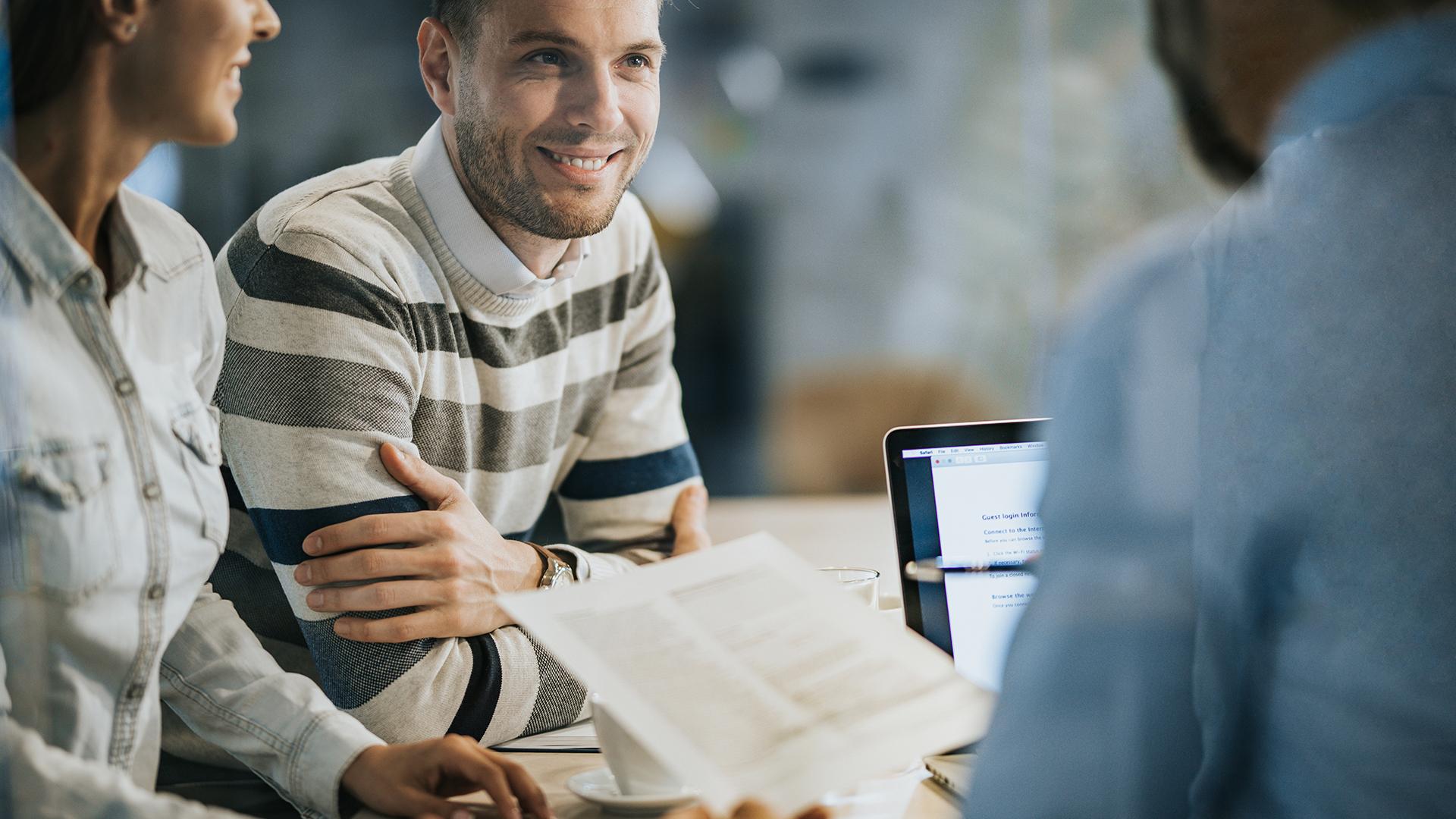 Young happy couple on a meeting with their insurance agent.