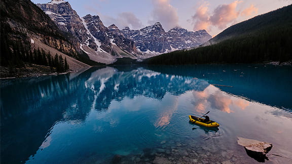 Mountain range reflects in the blue water