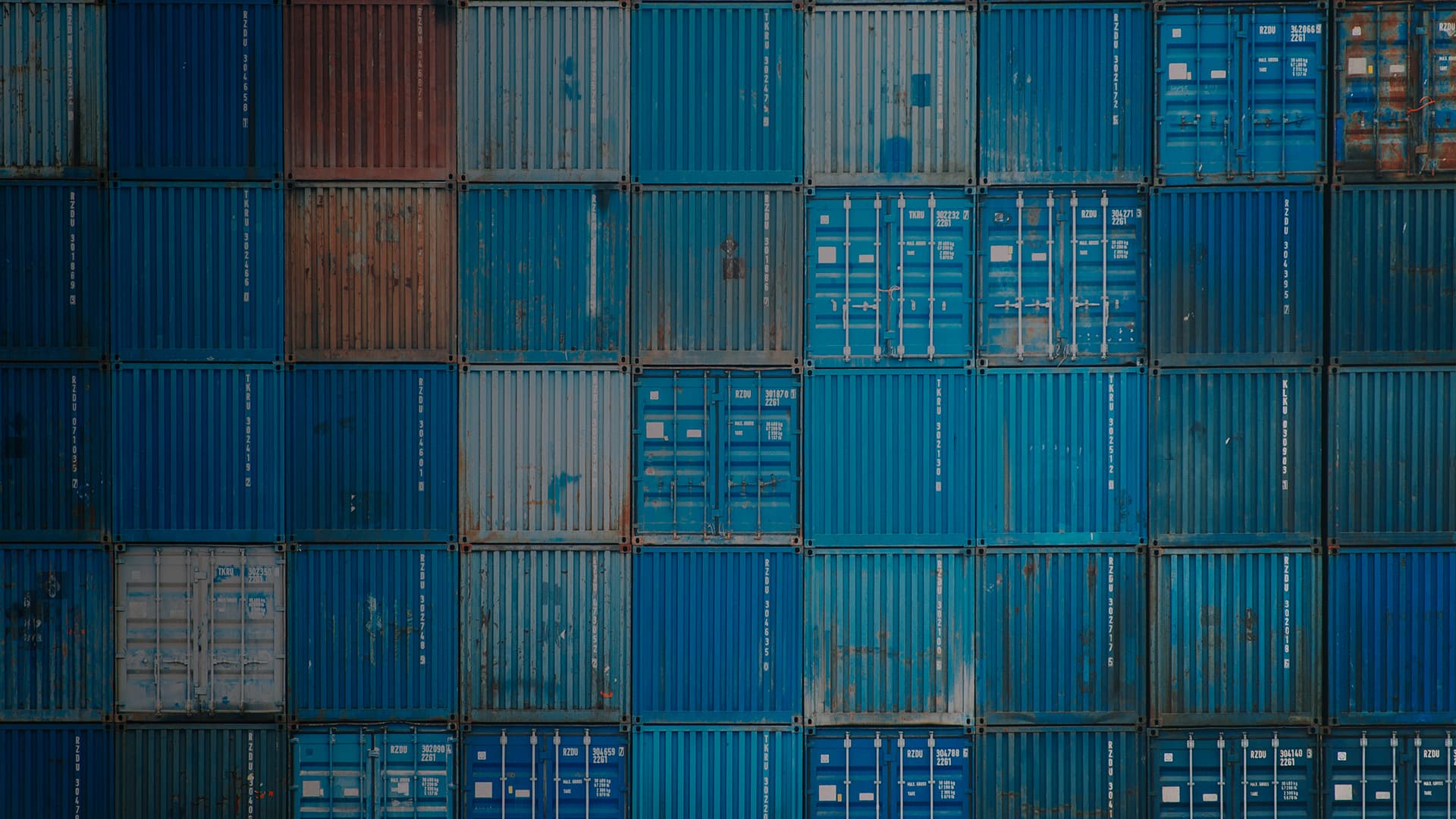 Myriad cargo containers stacked in a port.