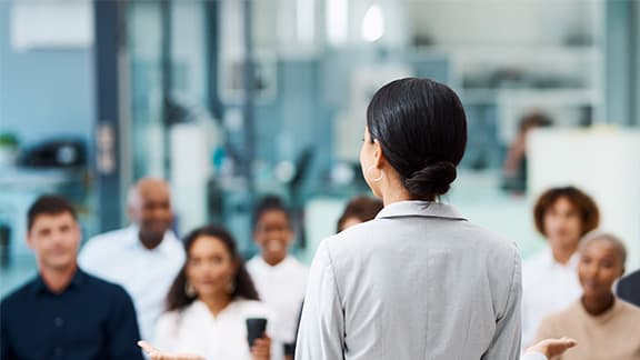 A healthcare professional speaking to a group of people.