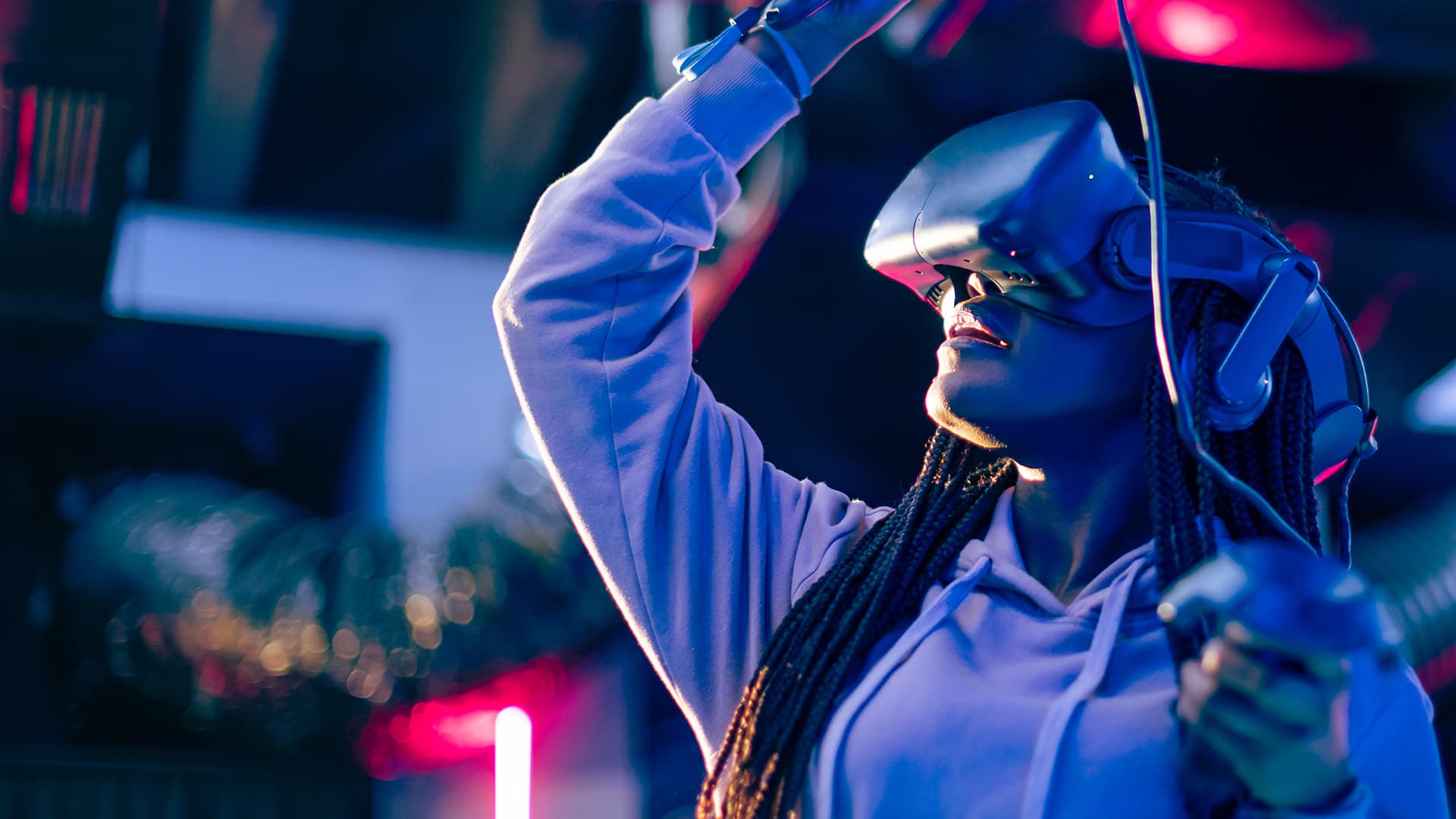 Young woman using a Virtual Reality headset and controller.