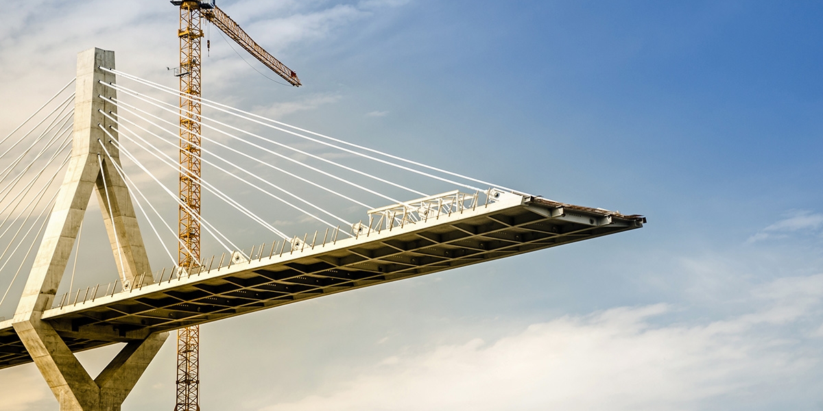 Incomplete suspension bridge under construction.