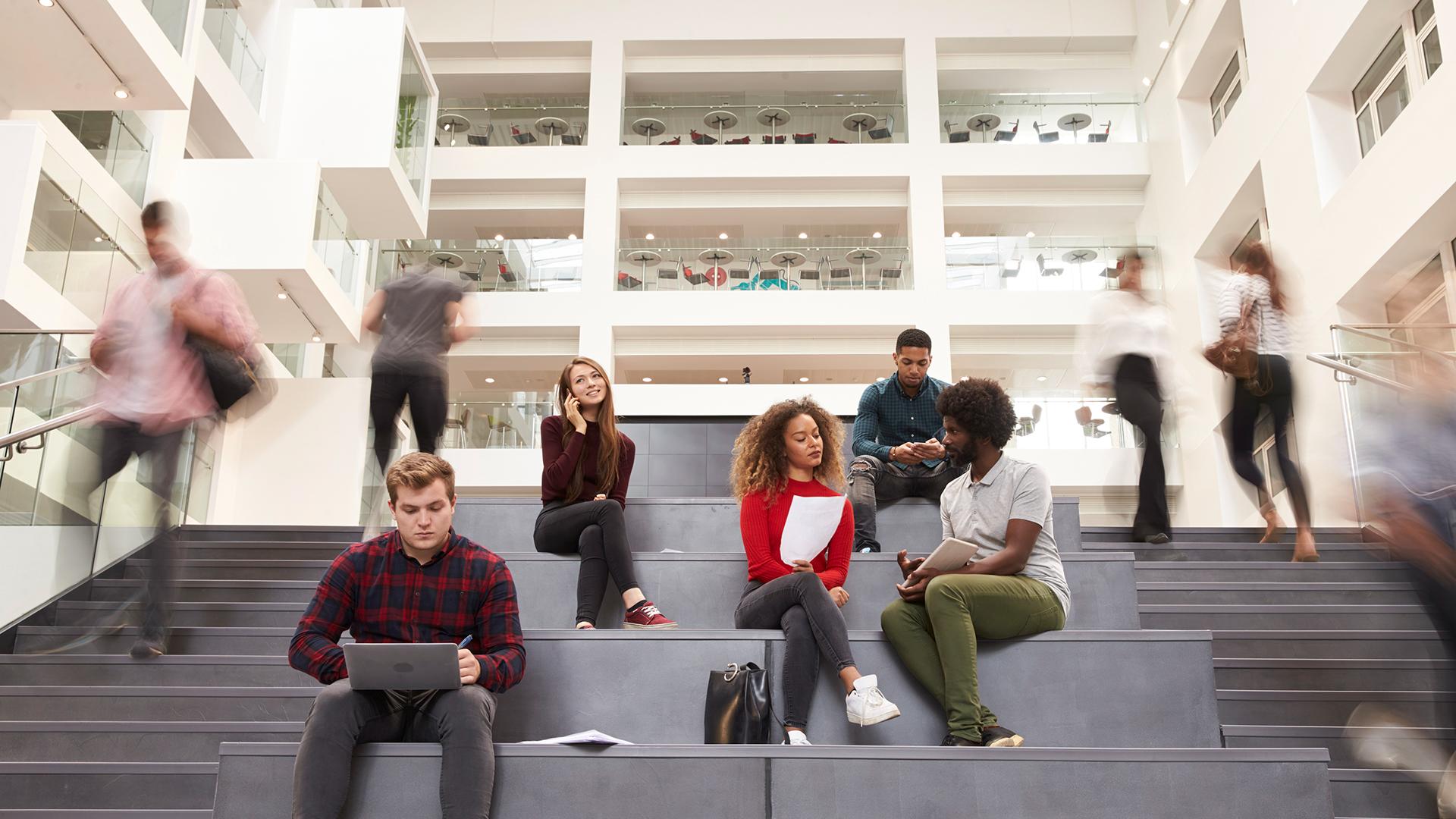 Interior of busy university campus building with students