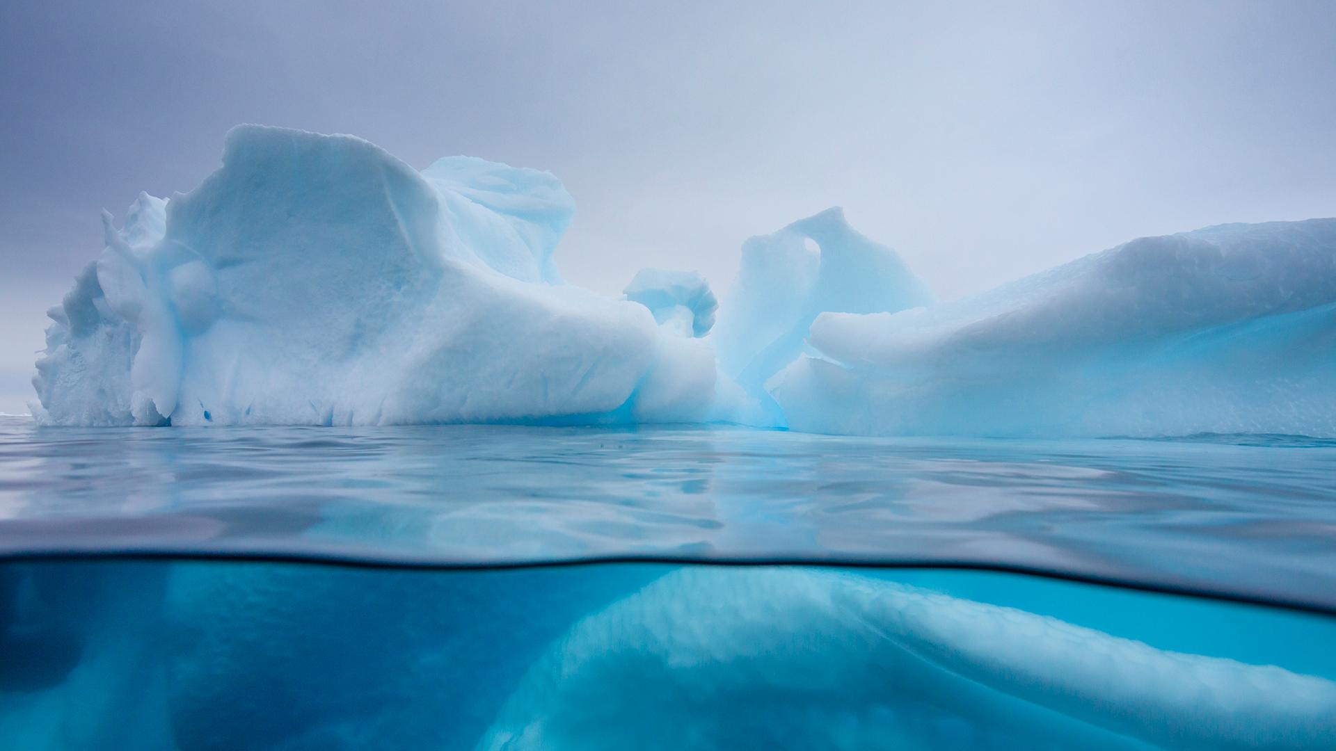 An iceberg partially submerged in water.