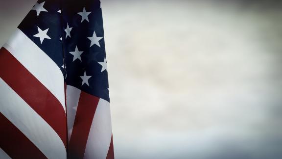 American flag pictured against a gray sky