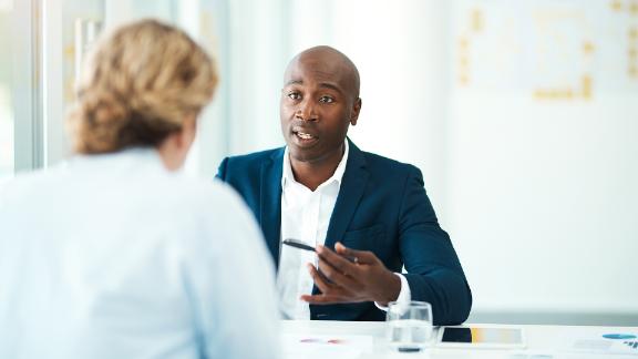 Defocused shot of a woman meeting with a professional businessman