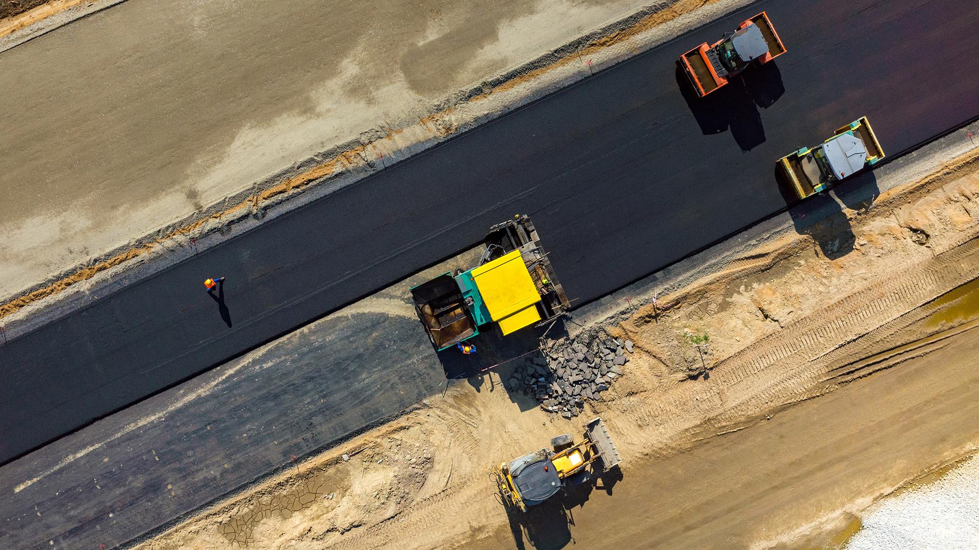 Road rollers working on a construction site aerial view