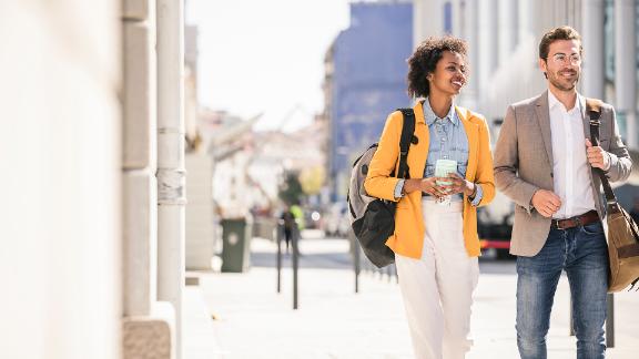 Young man and woman in the city on the go