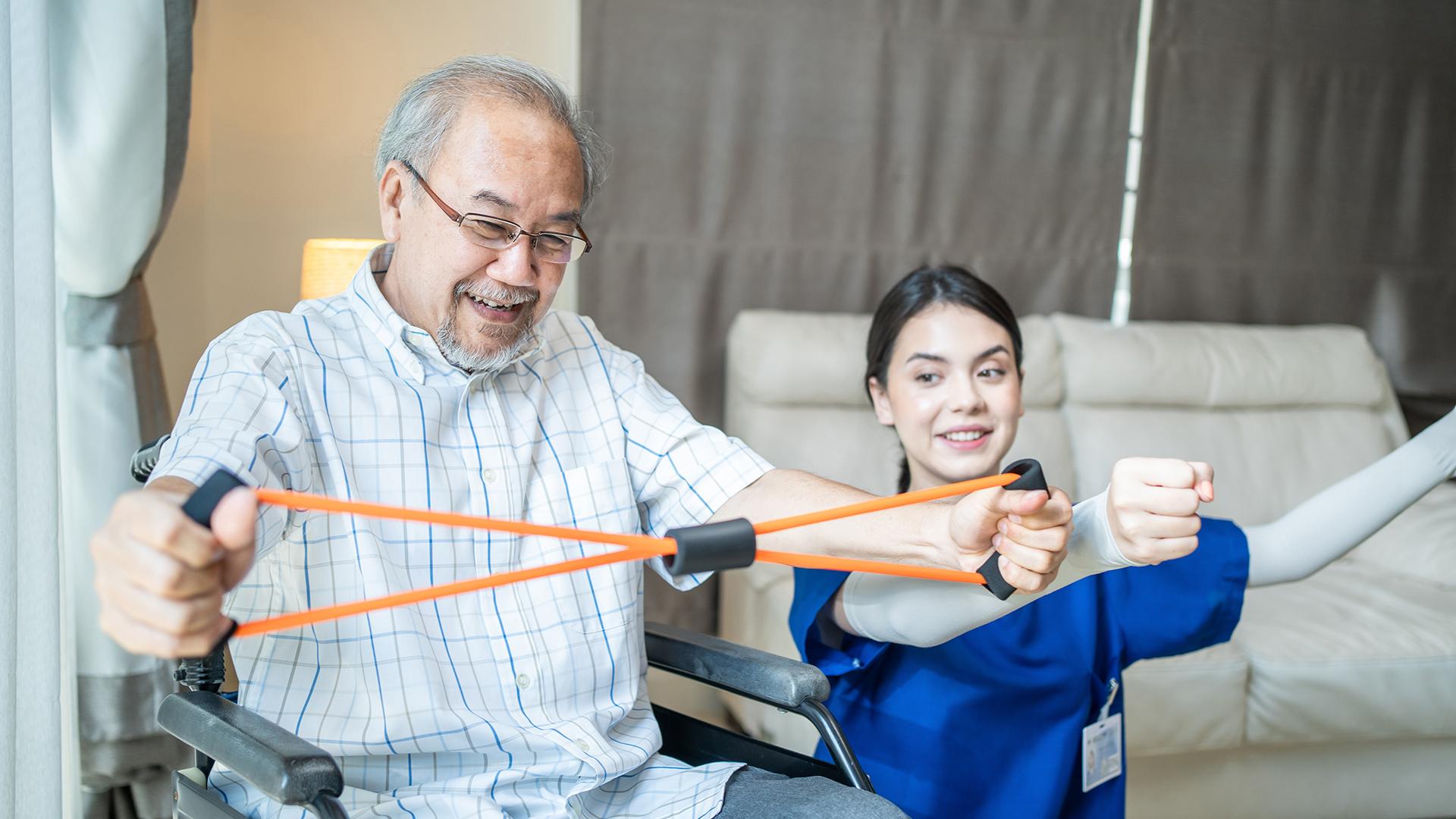 An older man working with a Physical Therapist.