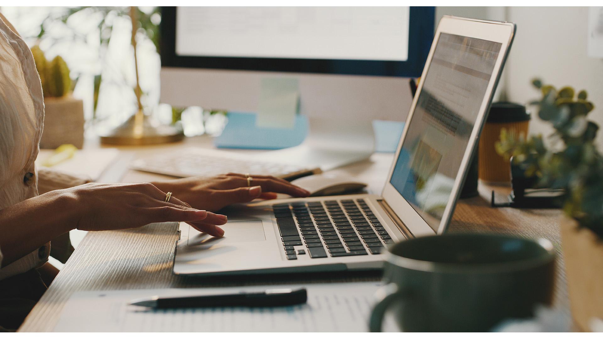 businesswoman sitting and using her laptop while working from home