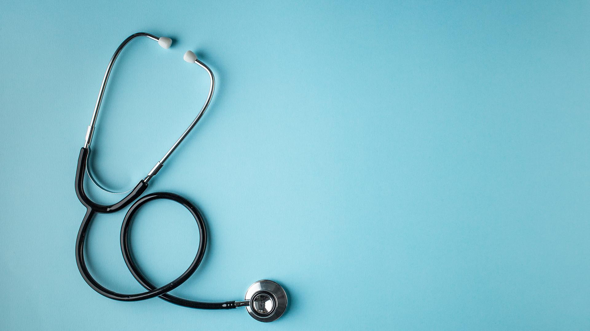 A stethoscope on a blue surface.